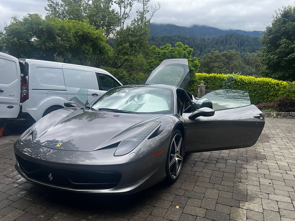 Exotic rosso corsa Ferrari 458 Spider supercar receiving a premium mobile full detailing service in