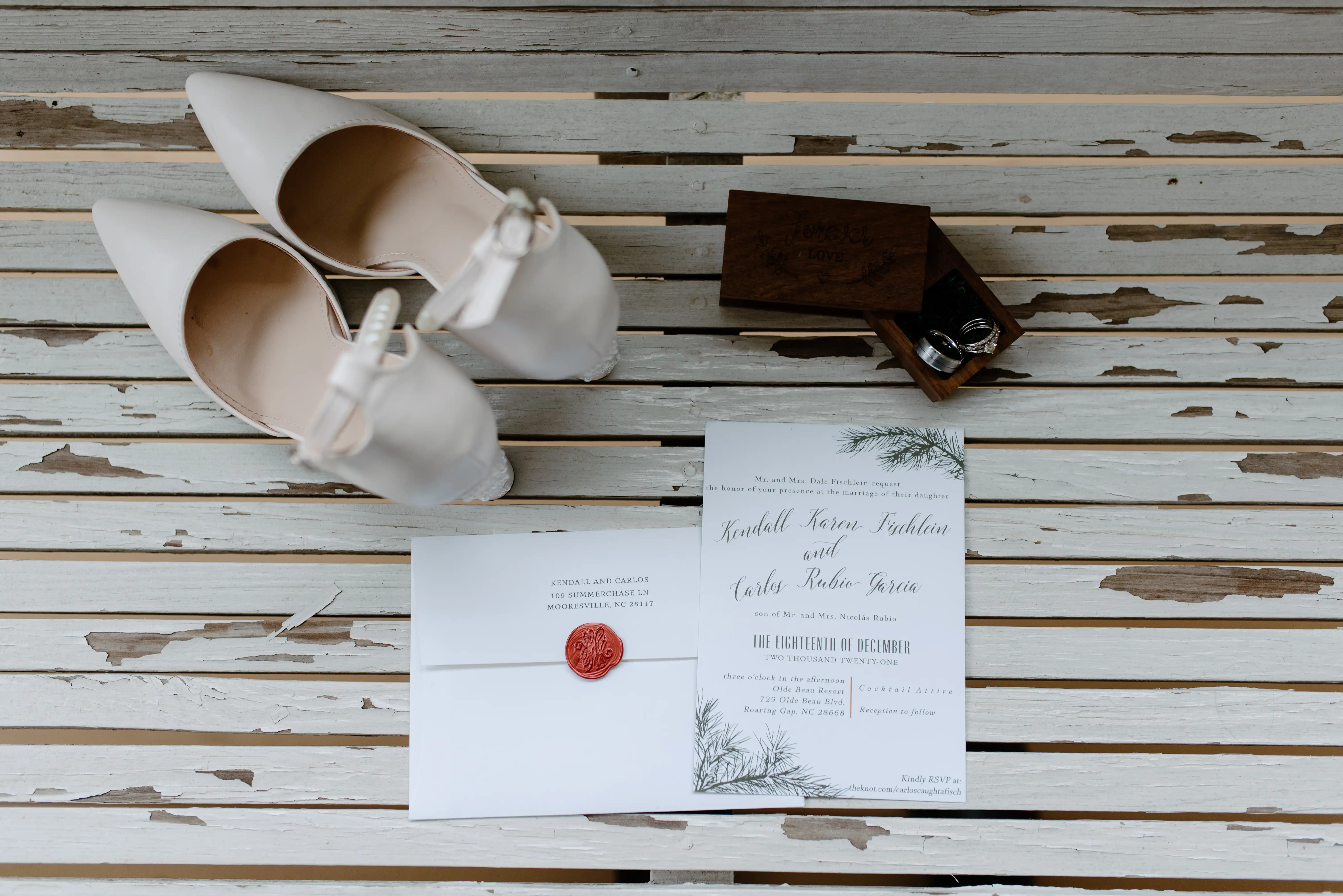 Wedding envelope and invitation with white heals and wedding bands