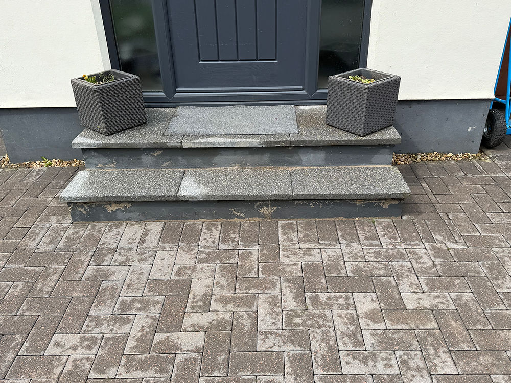 Dirty steps and pavers needing professional pressure washing.
