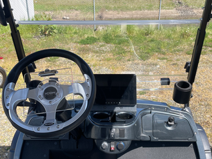 Deluxe two-tone seats made from marine grade vinyl, 10" digital display, carbon fiber dash, 2 USB charging ports, locking glove boxes, 2 additional cup holders, and score card holder.