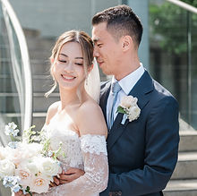 Bride and groom posing by a staircase on their wedding day