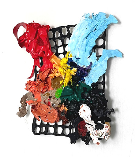Thick paint blobs in bright colors pressed onto a black plastic grid, like a chromatic creature caught in a lattice.