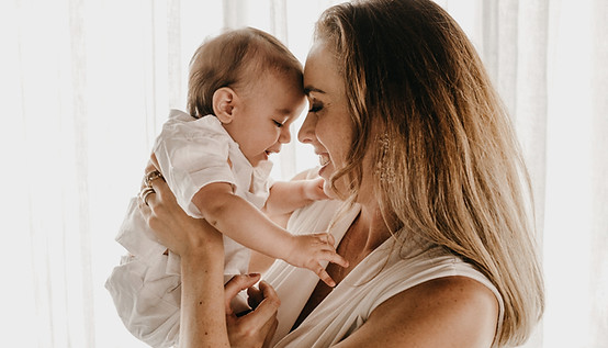 smiling woman carrying baby_edited.jpg