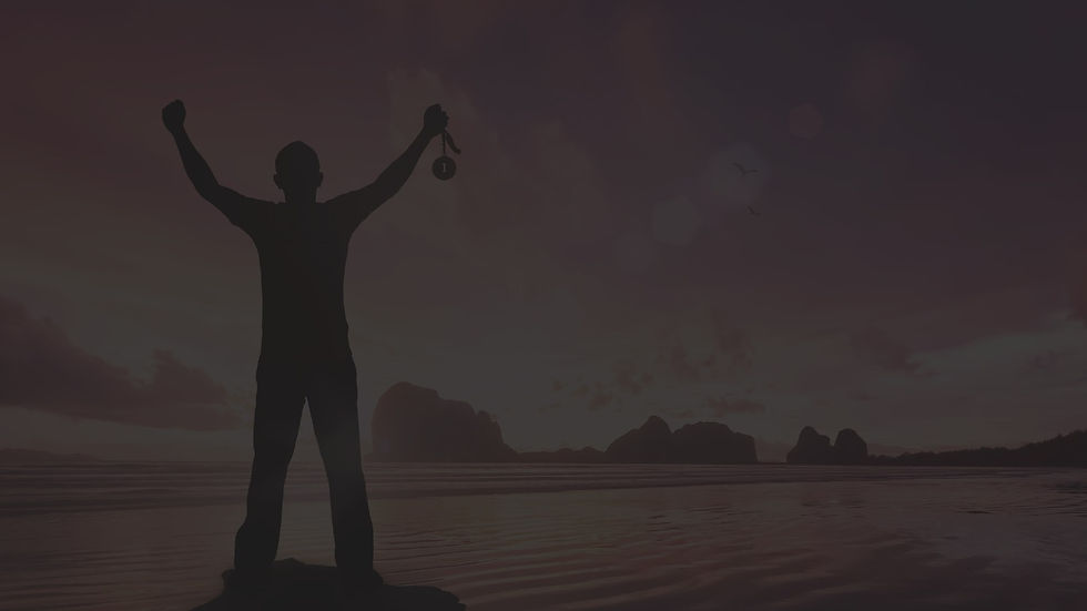 Man holding up arms with medal in hand.