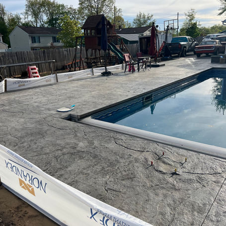 Backyard pool and pool sidewalk construction