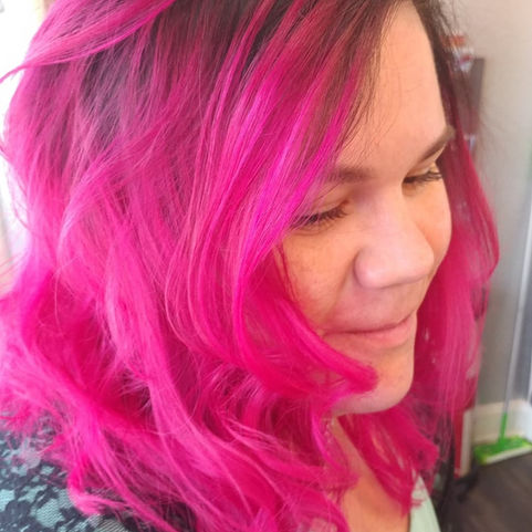Client with shoulder length fuchsia waves, courtesy of Hubris Salon.