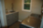 Luxury laundry room remodel with grey cabinets and large laundry sink