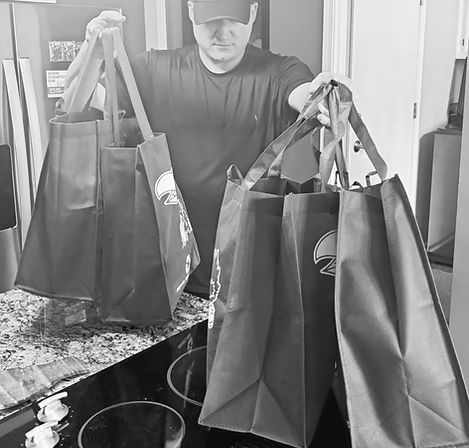 Person performing household assistance by bringing groceries and shopping into home