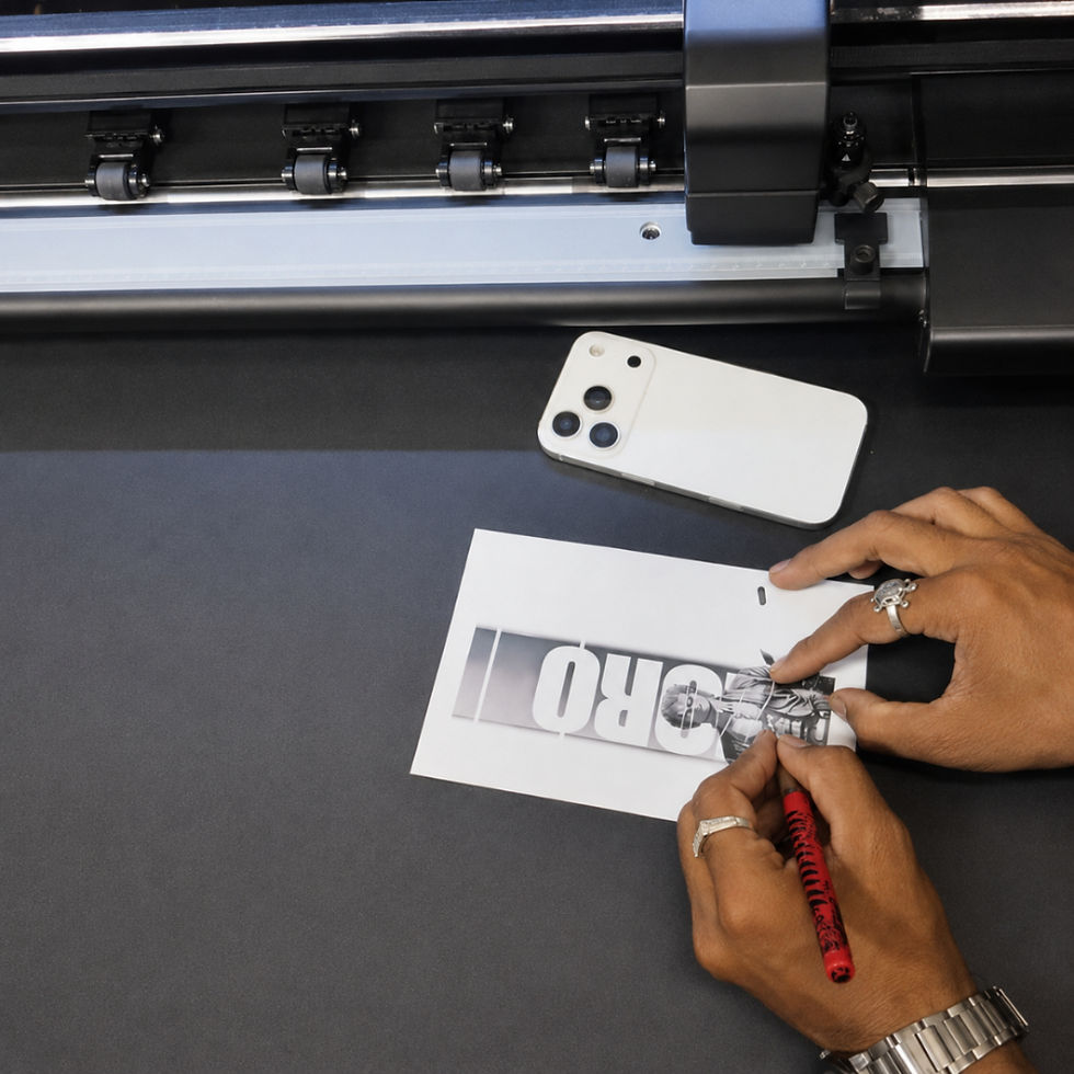 Person using a cutter to trim a printed mobile skin design by hand