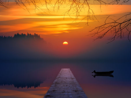 Golden sunset over a tranquil lake with a boat floating near a wooden pier, symbolizing reflection, peace, and new beginnings.