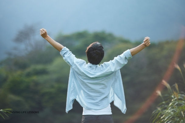 A person standing alone in nature, looking thoughtful but hopeful, symbolizing inner trust rebuilding