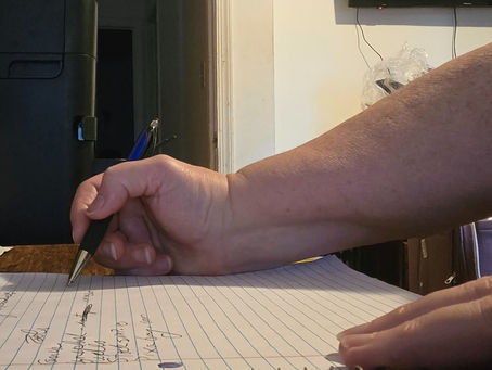 Close-up of handwritten notes on messy background, symbolizing how writing brings clarity and meaning to chaos.