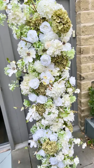 Elegant floral installation featuring white roses, hydrangeas, and greenery, crafted from premium artificial flowers, perfect for weddings, corporate events, and home décor.