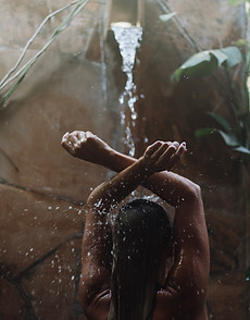 Tropical Shower in Bustani-Spa - a lady enjoying the nature surrounded shower