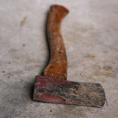 Scuffed and Scratched Hatchet on Cement