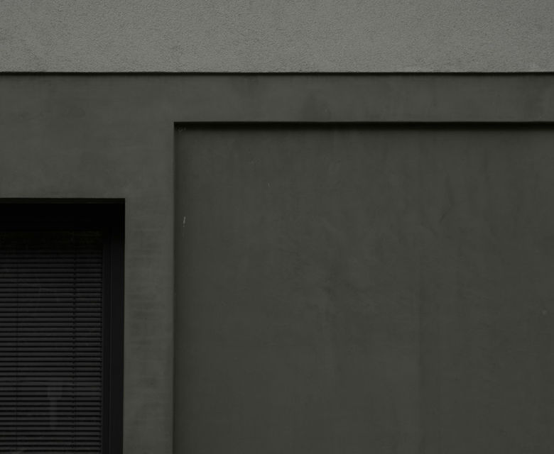 a black and white photo of a building with a closed door