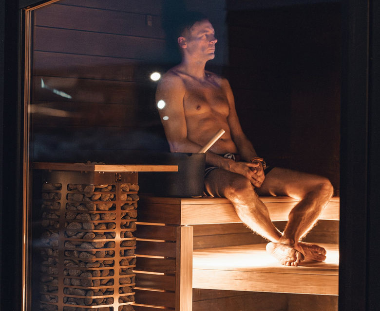 A man relaxing in a sauna.