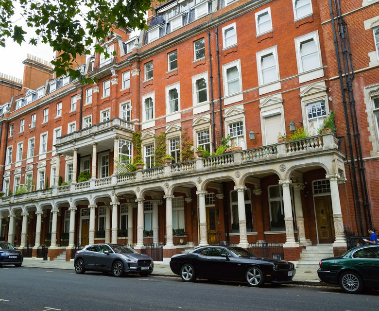 a row of cars parked on the side of a street