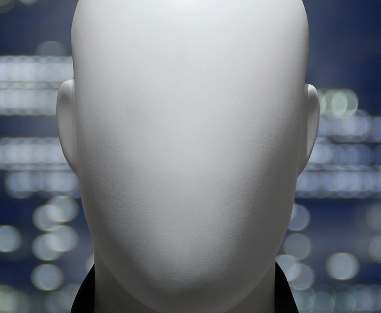 a white mannequin's head in front of a cityscape