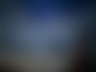 A woman reads with mountain landscape in the distance