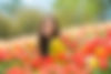 a-happy-woman-sitting-in-a-patch-of-tulips-2024-09-22-17-19-52-utc.jpg