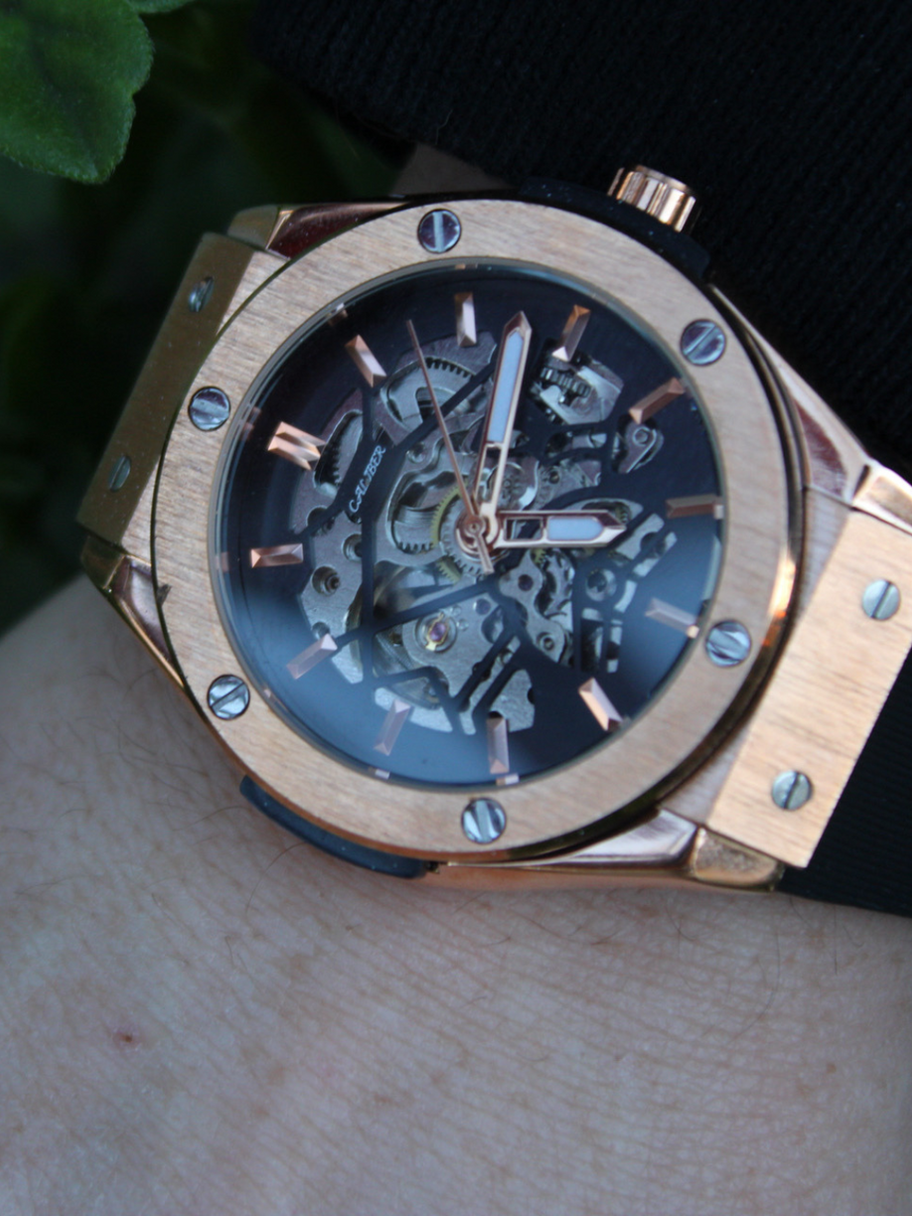 Caliber Watches Beretta Eclipse on the wrist – Elegant rose gold skeleton watch with a refined black strap.