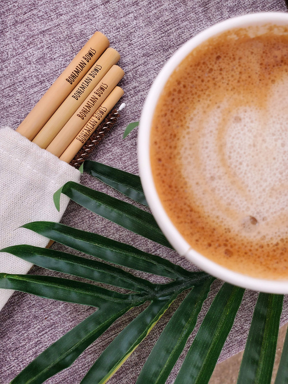 Thumbnail: Bohemian Bowls Four Count Hand Sanded Bamboo Straws With Coconut Husk Straw Cleaner In Linen Bag Next To Cappuccino and Leaf