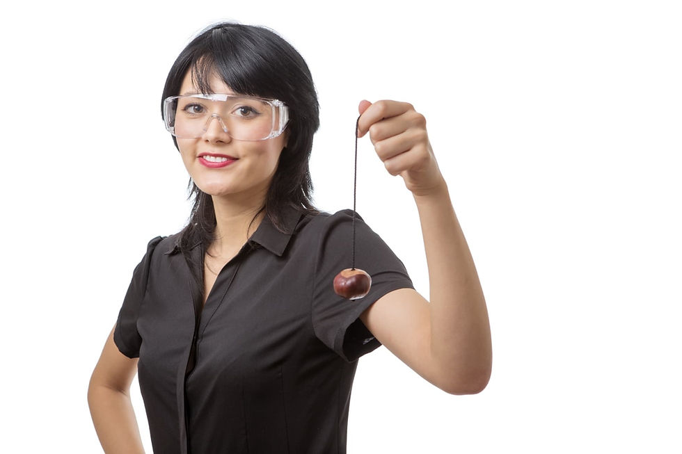 Studio shot of a business female wearing protective glasses ready to play conkers