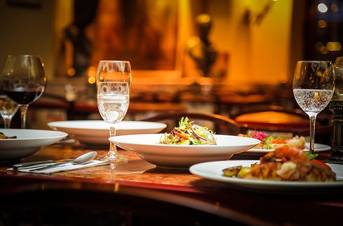 Beautifully arranged table featuring plates of food and wine glasses
