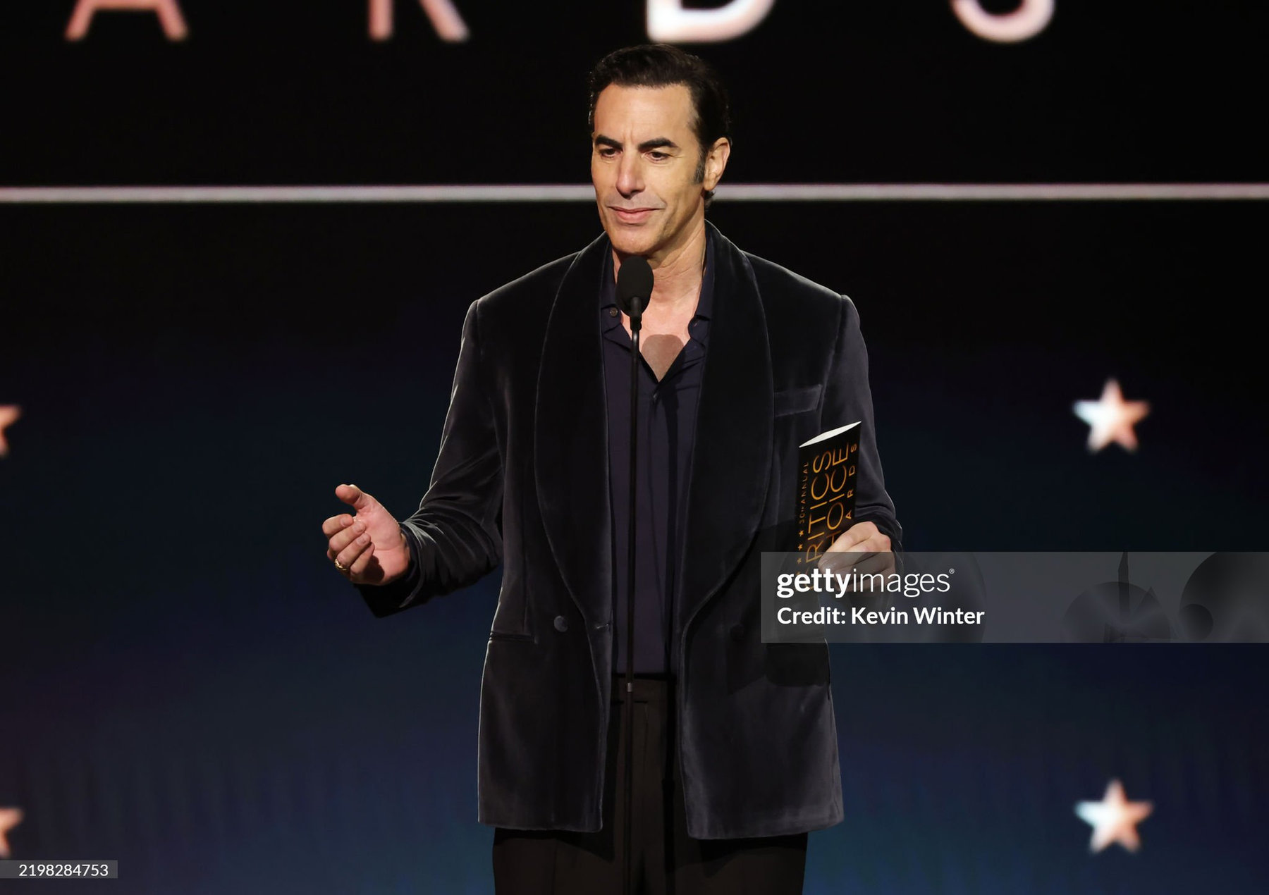 Sacha Baron Cohen Stuns in Thom Sweeney at the 30th Annual Critics’ Choice Awards