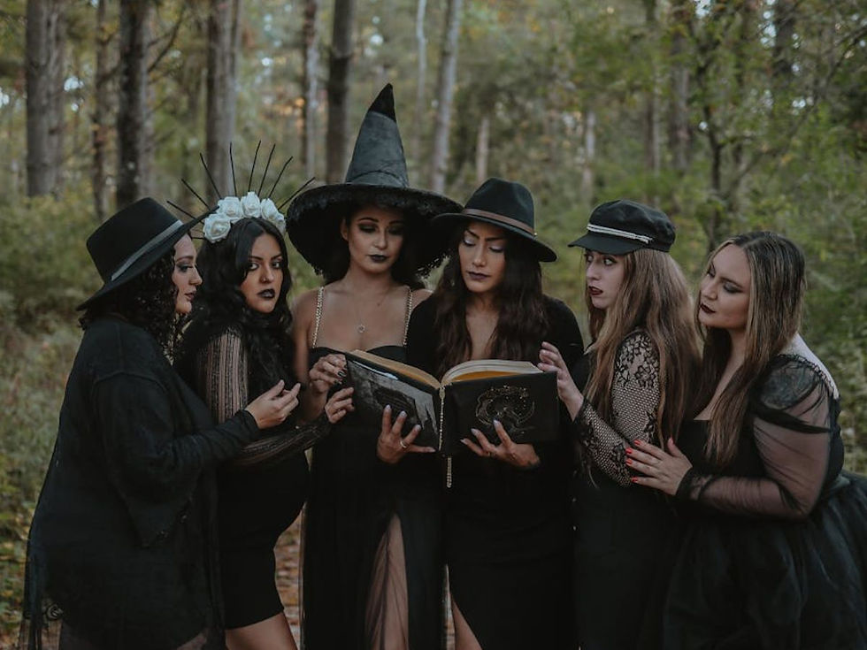a group of young witches looking to a grimoire