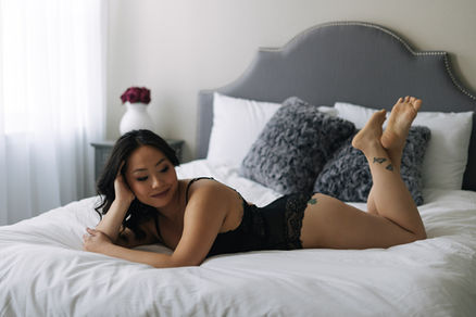 Woman smiling during her luxury boudoir session at Wild Orchid Boudoir in Maryland