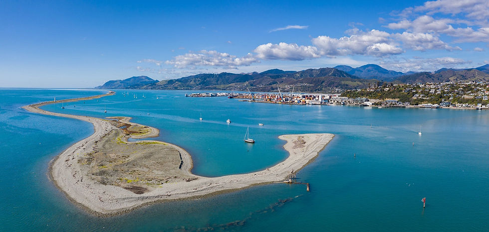 Thumbnail: Aerial view of a coastal area near Nelson, with a sandy spit extending into blue waters. Sailboats scattered around.