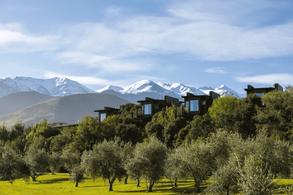 Hapuku Lodge in Kaikoura with a stunning vista of mountain backdrop, emphasising the serene and picturesque natural surroundings.