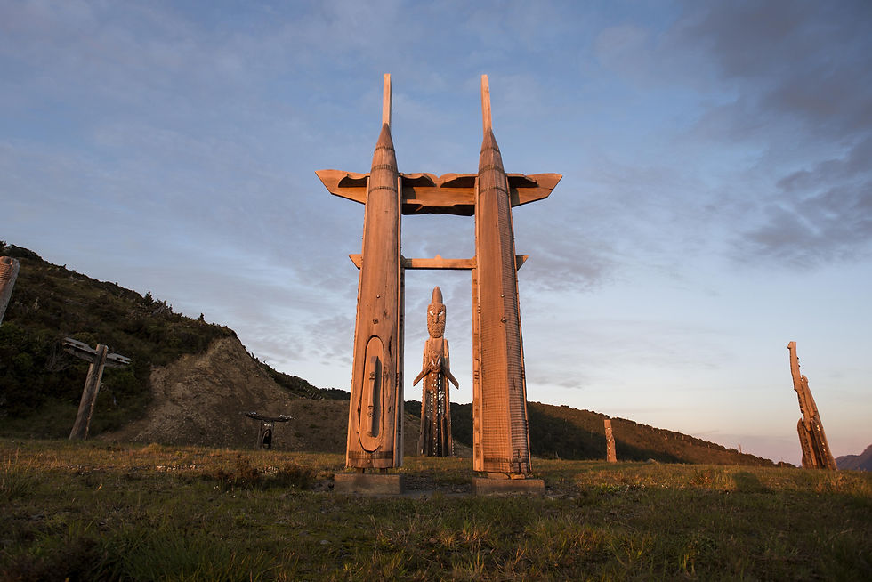 Thumbnail: A wooden carved structure stands on a grassy hillside of Mount Hikurangi, under a cloudy sky in Tairāwhiti Gisborne.