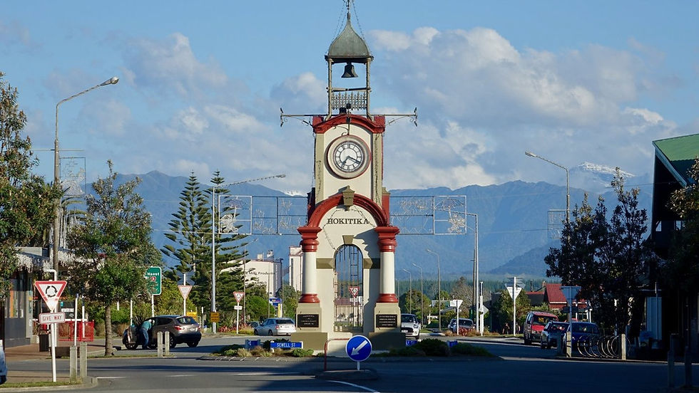 Thumbnail: The clock tower in Hokitika, New Zealand, marks the heart of Pounamu Trails. It stands majestically with a mountain backdrop.