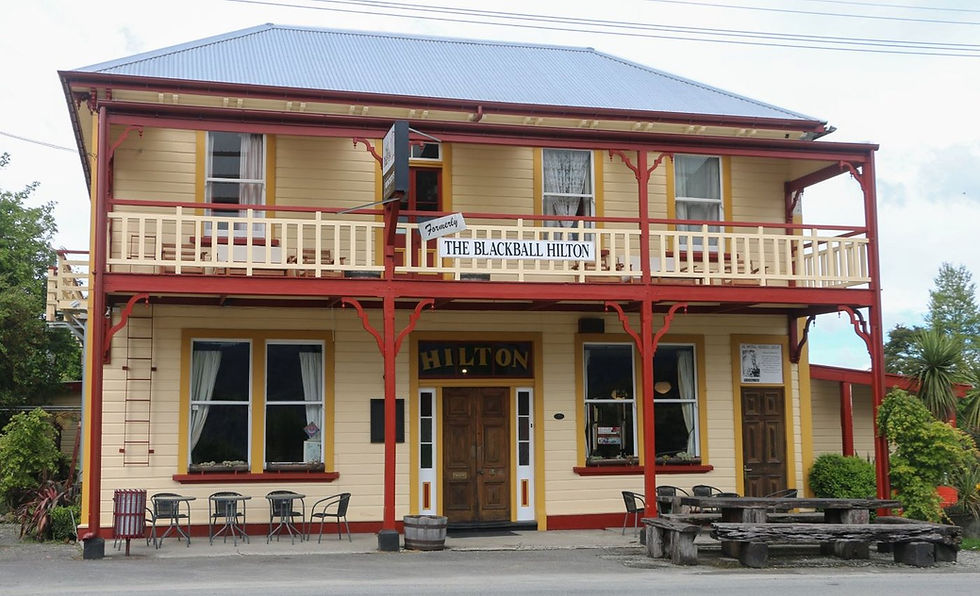 Thumbnail: The two-story wooden building, labeled The Blackball Hilton, features a balcony with a railing and a tavern sign.