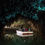 Thumbnail: A boat floats inside a cave illuminated by enchanting, glow worm lights, creating a mystical atmosphere.