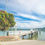 Thumbnail: A white wooden jetty spans gracefully over the serene Hokianga Harbour, reflecting the surrounding natural beauty.