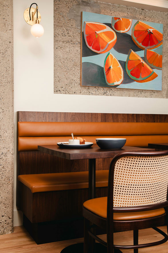 Brucato Amaro dining room with earthy tones and art reflecting Italian amaro heritage.