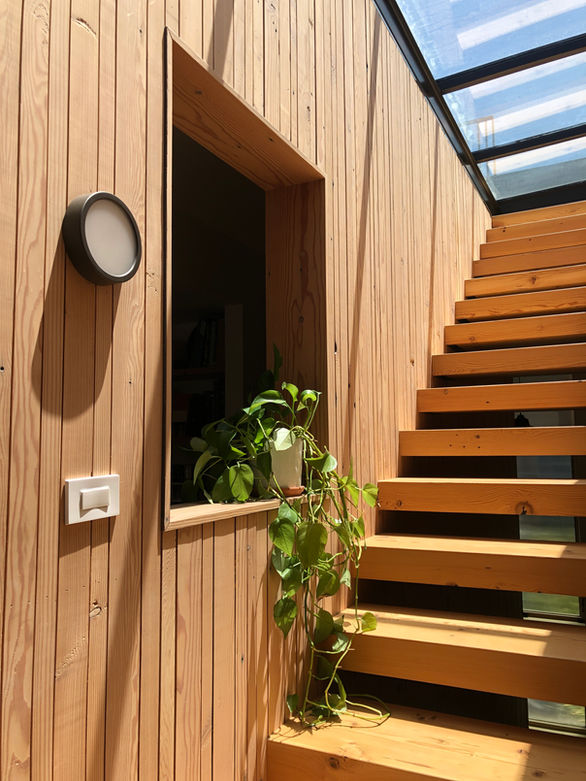 Hayes Valley House interior detail stairs with natural light, skylight detailing and light woods.