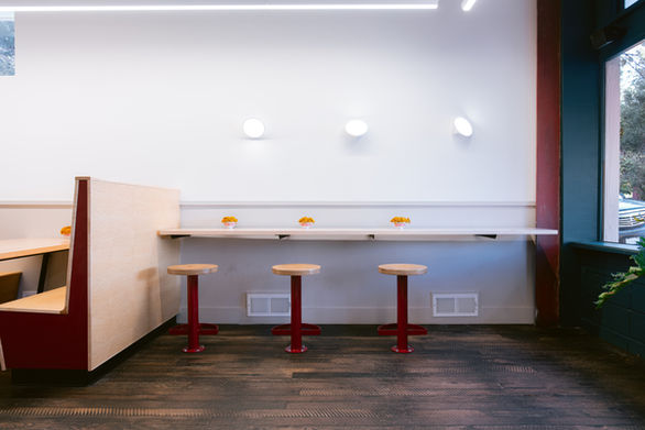 Mamahuhu Mill Valley with fast casual tables and chairs  with on-brand accent colors diffused warm playful light and high-quality sophisticated playfulness.