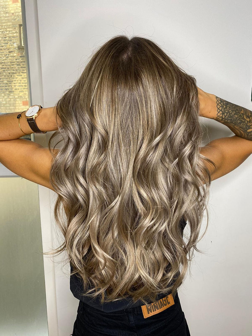 Long ash blonde hair with seamless fine highlights and natural root depth