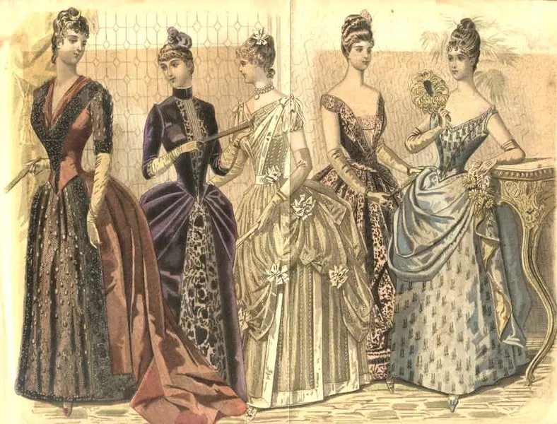 Five women in ornate 19th-century gowns, featuring patterns, lace, and bows. They stand elegantly in an ornate room, exuding refinement.