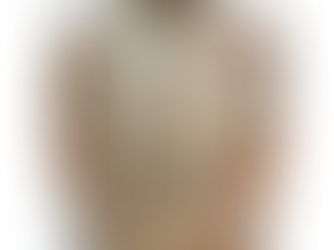 Blonde wavy hair is shown from the back, with hands touching it. The person wears a brown sweater. The background is plain white.