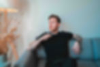A man seating on a sofa