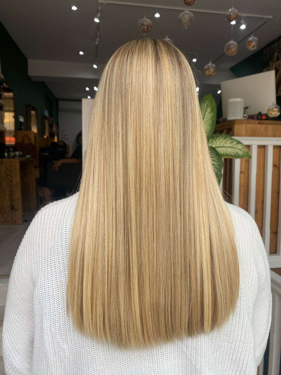 Long blonde hair with highlights facing away