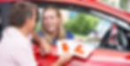 A driving instructor hands over L plates