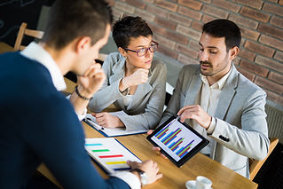 Business people discussing market research statistics during business meeting