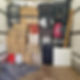 A moving truck filled with various luggage and boxes stacked in the back.